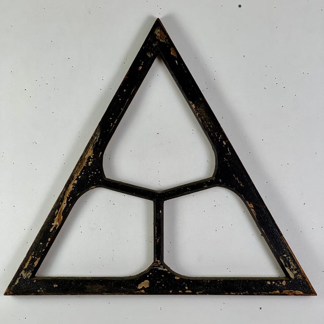 A unique and now decorative architectural salvage window frame. It's equilateral triangle design with it's 3 honeycomb...