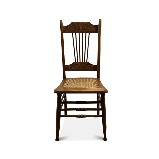 A farmhouse pressed back cane seat chair that features an upper and lower pressed back rail with an intact cane seat. The...