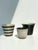 A rare and color-coordinated set of three plant pots from the 1950s: a horizontally striped, hand-thrown piece from veb...
