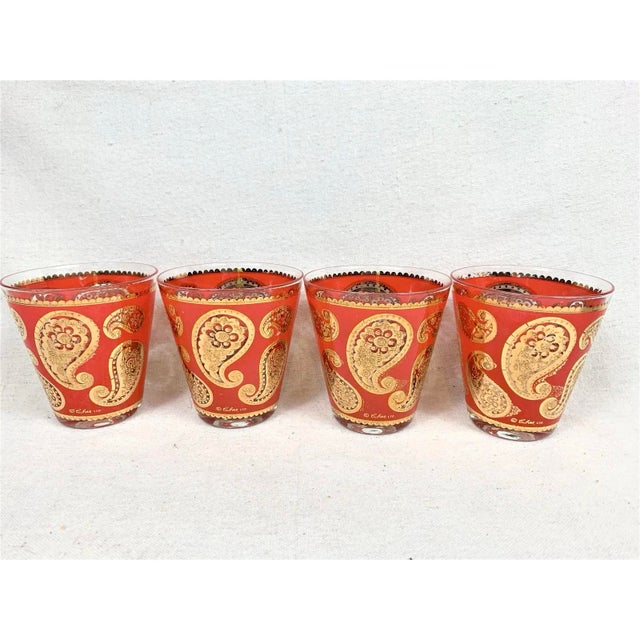 Stunning vintage mid-century Culver rocks glasses featuring a striking red and 22-karat gold paisley pattern. Produced by...