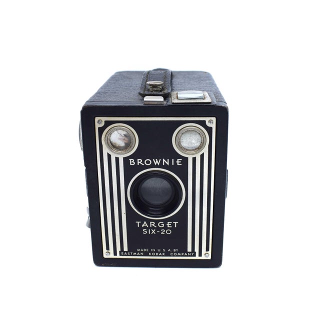 This Eastman Kodak Brownie Target Six-20 is a striking example of mid-century industrial design, featuring a bold Art Deco...