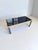 Dining table made of black painted glass and black lacquered wood and maple. The table was designed by Pierre Cardin for...