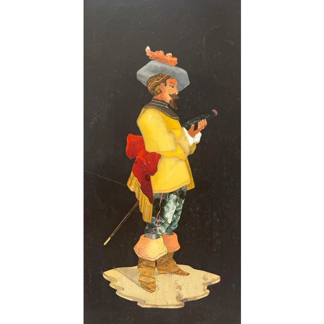 A 19th Century Italian Pietra Dura Plaque depicting a a cavalier, holding a rapier and appearing to drink a toast. The...