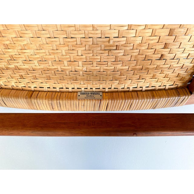 The very rare Jørgen Høj Teak and Rattan Chair for Thorald Madsen is a prime example of 1950s Danish modern design....