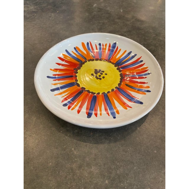 This is a beautiful vintage Italian ceramic plate with a hand painted floral detail on the top center of the plate. It has...