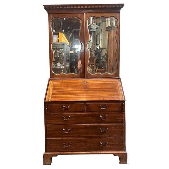 DETAILS Hand fashioned of beautiful slightly figured mahogany, this lovely antique desk features double doors with...