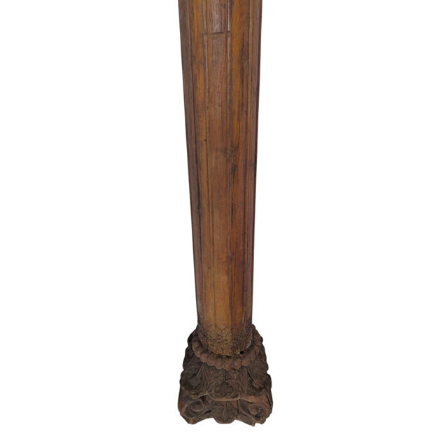 Pair of decorative carved wooden columns, in the Balinese manner, probably 19th century. Fluted shafts. Each capital is...