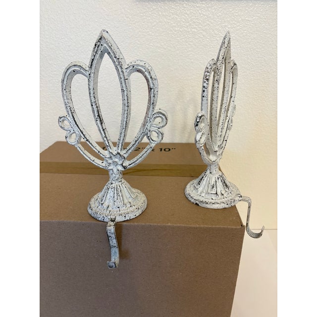 These two items are weighted cast iron mantel stocking holders designed to sit securely on a ledge or fire mantel. They...