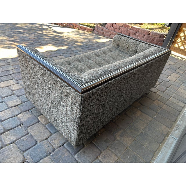 Stunning 1960s-1970s mid-century modern sofa featuring a bold dark wood (rosewood-style) frame with polished chrome inlay...