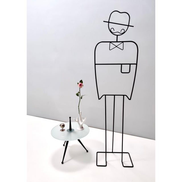 Made in Italy, 1980s. This is a reinterpretation of Cesare Lacca's design of a tripod coffee table in the 50s. This coffee...