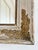 An antique French Napoleon III-style wall mirror, dating to the late 19th century. The mirror has a wide wooden frame with...