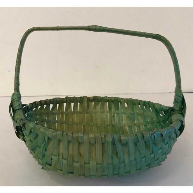 Cute little Asian basket dyed green with a fixed handle.