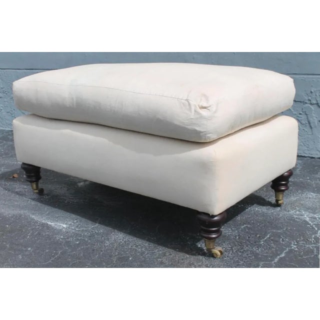 George Smith Ottoman with a removable down cushion top on the Elverdon style mahogany turned legs with brass casters.