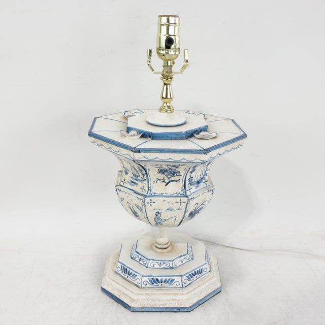 This vintage metal table lamp features a striking octagonal urn silhouette finished in a classic blue and white palette...