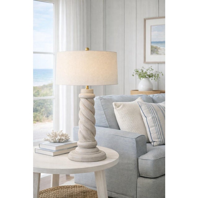 A substantial 33” sculptural barley twist table lamp featuring a stone-inspired plaster finish with subtle blue-gray...