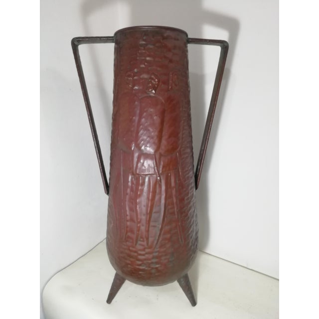 Characteristic umbrella stand by Angelo Bragalini in thick, embossed copper. Tripod. Three feet. Truly beautiful work with...