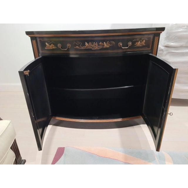 Mid Century Chinoiserie cabinet or server. Doors, sides and top embellished with decorative chinese motif scenes and...