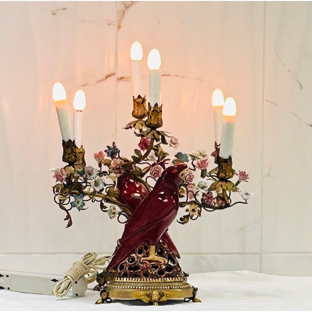 This is a wonderful pair of ormolu candelabras with 3 arms, each supporting a porcelain parrot. Decorated with porcelain...