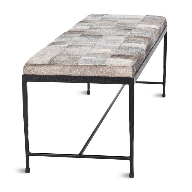 Modern beautiful hide upholstered bench in a square patchwork pattern of varying shades of grey. Black iron frame/legs...