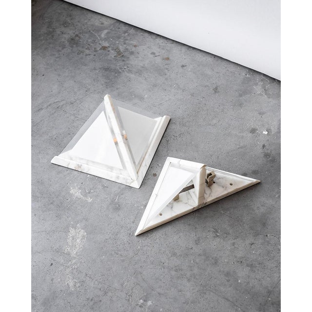 The lamps have a white Carrara marble structure and frosted glass inserts. from Italy and estimated that they are from the...