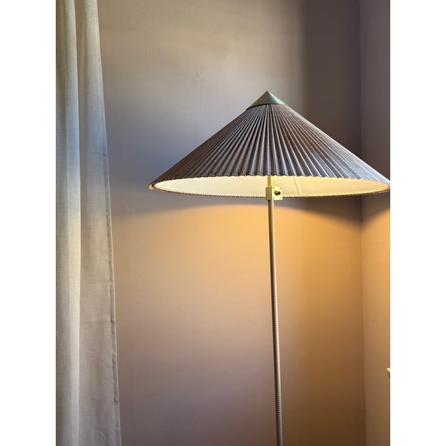 Characterized by its elegant and airy lampshade and rattan-covered stem, the 9602 Floor Lamp shows the designer's...