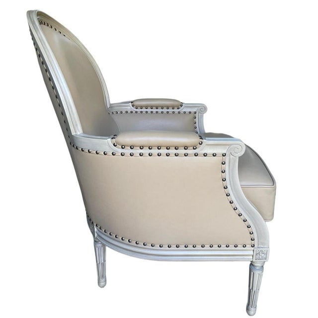 A refined vintage Louis XVI style armchair designed and produced by Paris-based designer Jean-Rémy Couradette in 2001. The...