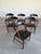 Set of 6 Danish Teak and black vinyl dining chairs, a nod to Kai Kristiansen’s model 31’s, but distinctly their own with...