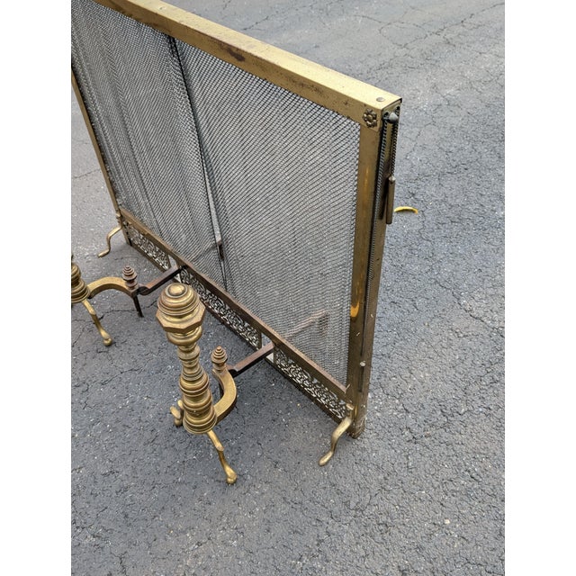 Elevate your hearth with this striking Midcentury Hollywood Regency brass fireplace set, featuring a pair of sculptural,...