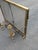 Elevate your hearth with this striking Midcentury Hollywood Regency brass fireplace set, featuring a pair of sculptural,...