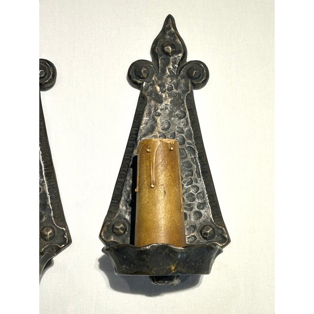 Spanish Revival Pair of Antique c.1920’s Art’s & Crafts / Spanish Revival Hammered Iron With Fleur-De-Lis Motif Wall Sconces With Original Candle Sleeve Socket Covers For Sale - Image 3 of 9