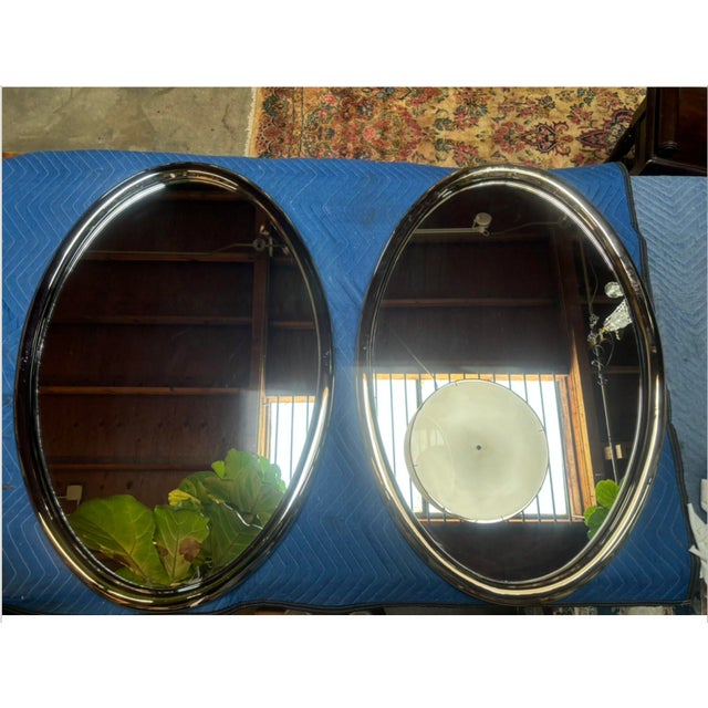 FUTURISTIC CHROME OVAL WALL MIRRORS Total of 2 mirrors. Can be sold separately or as a pair. Each $4,200. Solid bronze...