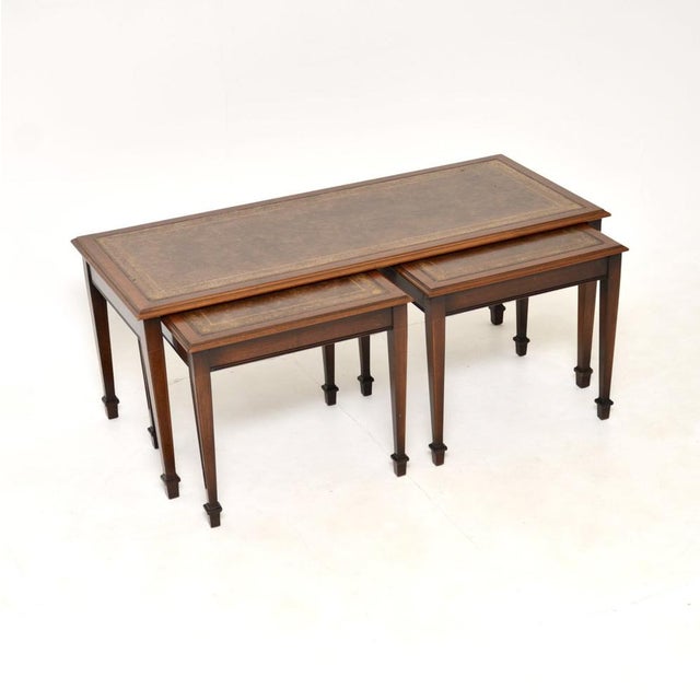 A wonderful antique leather top nesting coffee table / side tables. These were made in England, they date from around the...