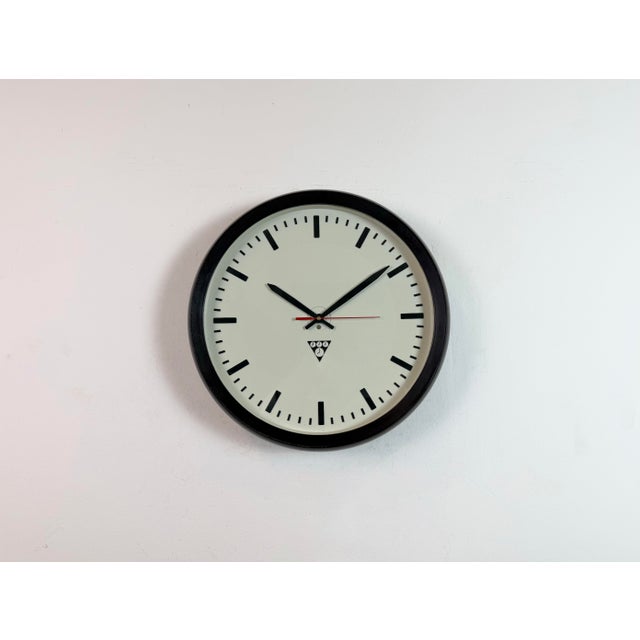 This wall clock was produced by Pragotron in former Czechoslovakia during the 1970s. The piece features a brown bakelite...