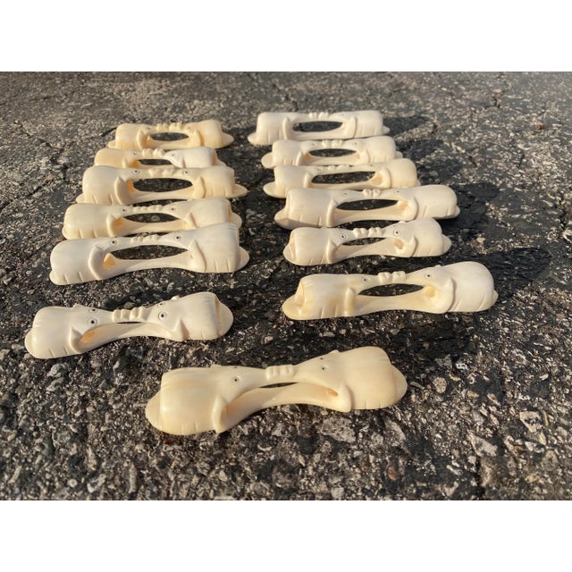 Vintage Antique carved Bone Knife Rests/ napkin rings- set of 13. Each one has two elephants, facing each other, connected...