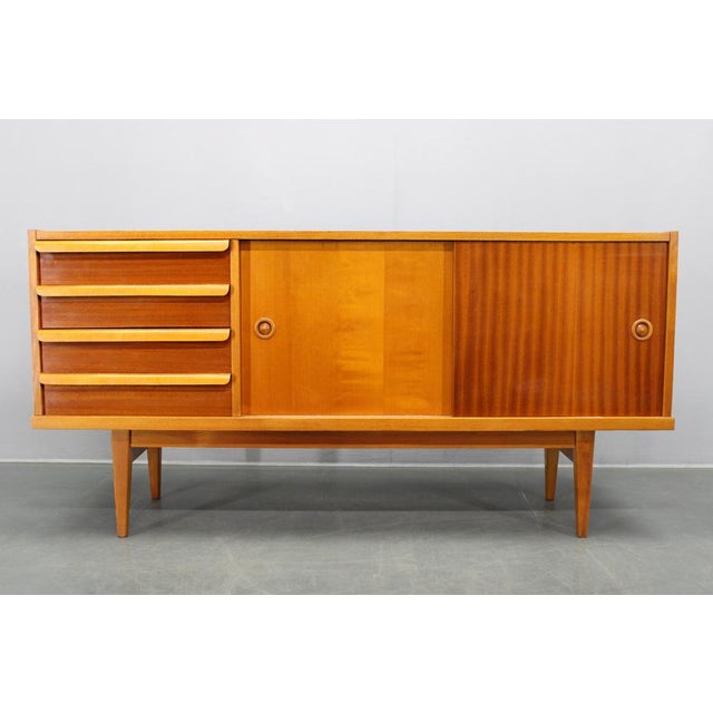 This elegant mid-century sideboard was produced in Czechoslovakia during the 1960s and reflects the clean geometry and...