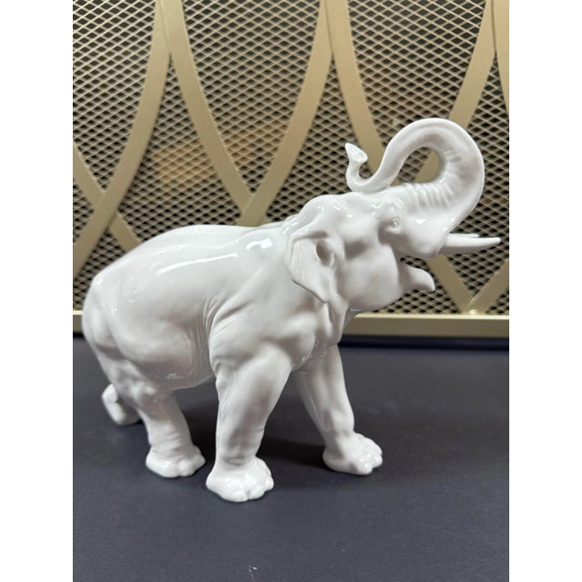 Vintage white porcelain elephant figurine stands 8.25” tall with trunk up. A fine neutral styling piece for a bookshelf or...