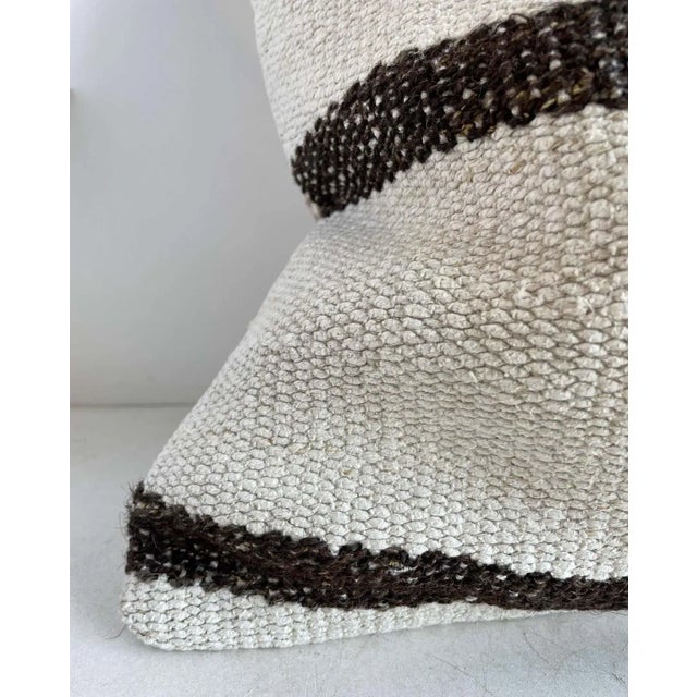Unique pillow has been made with a turkish rug, in multiple white tones, and some variations of white woven through with...