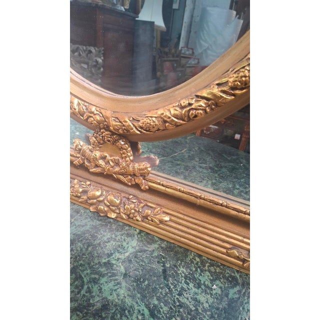 Louis XV/Louis XVI Transition style mirror. This mirror was made in the 1970s. It is in very good condition. Period: 20th...