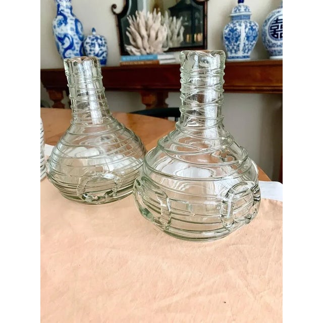Extremely unique pair of Mid-Century Italian clear hand blown art glass carafes or vessels wrapped in applied glass in a...