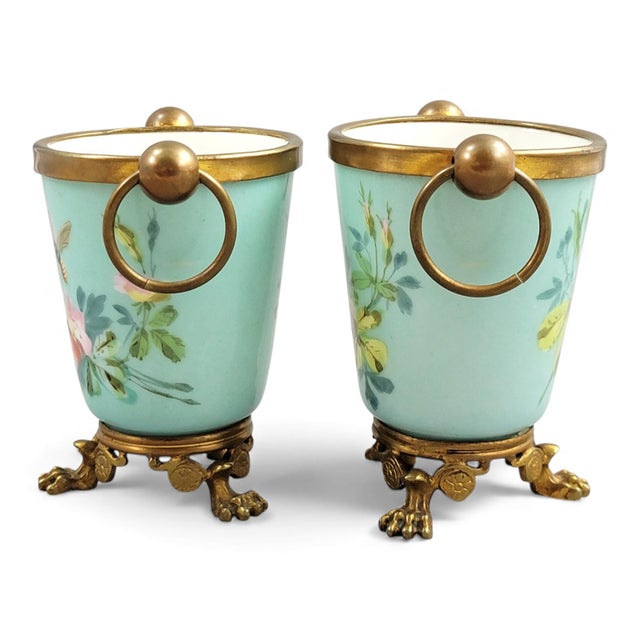 A compact and decorative pair of Old Paris cache-pots with turquoise enamel and original gilt bronze mounts, produced...