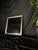 Square wall mirror with a substantial frame in a soft champagne-silver / light gold-tone metallic finish and a clean...