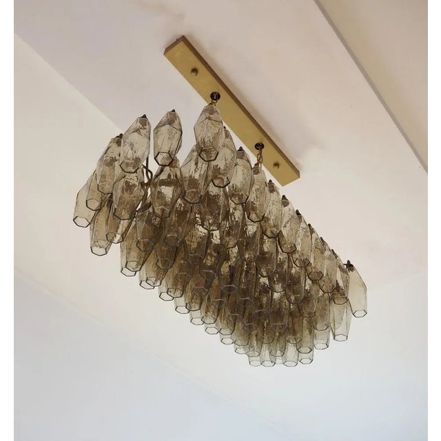 Elegant italian chandelier made from 84 beautiful murano smoked glasses "poliedri". Structure in gold and brass colored...