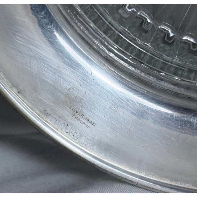 Elegant vintage English lead crystal bowl mounted on a removable silver plate pedestal base. The bowl features a classic...