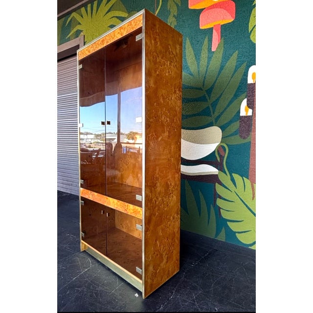 Perfect curio cabinet to appease both mid century and postmodern aesthetics. The burl case is a showstopper and sure to...