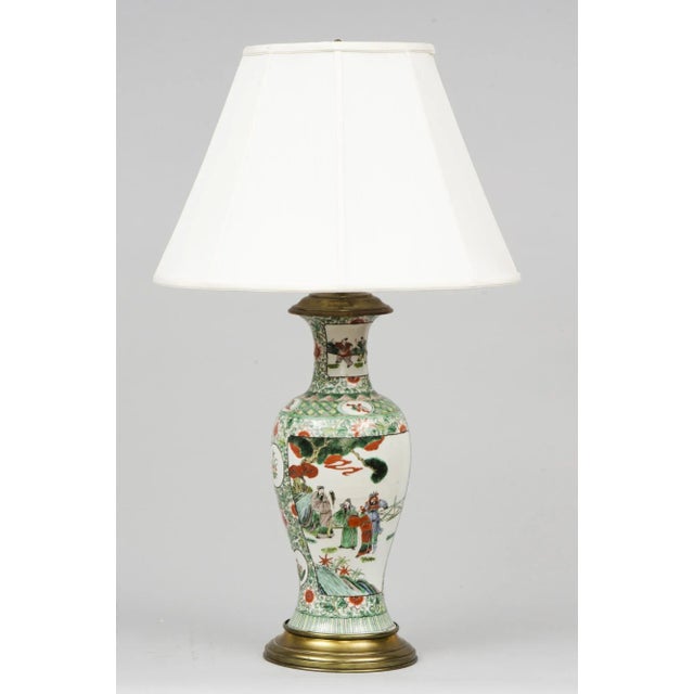 Chinese Famille Vert porcelain baluster-shaped lamp mounted on a bronze base, the panels front and back are decorated with...
