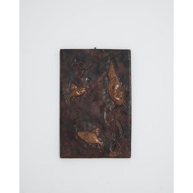 Made Denmark in the 1960s, this charming copper artwork depicts a trio of fish swimming in the sea. Made with the repoussé...
