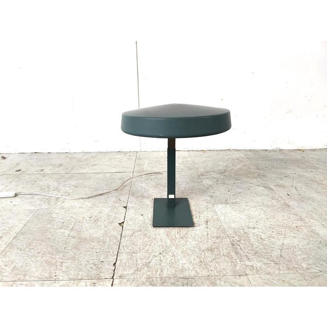 Rare green metal and brass desk lamp designed by Louis Kalff for Philips. The lamp is in a good original condition with...