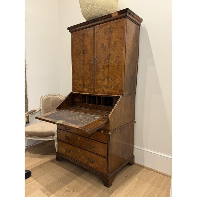 French Louis XV style secrétaire à abattant featuring an elegant bombe-form base, richly figured wood veneers, and...