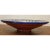 Large-scale terracotta bowl with bright blue, yellow, and red geometric patterns. An ornamental piece that is refined with...