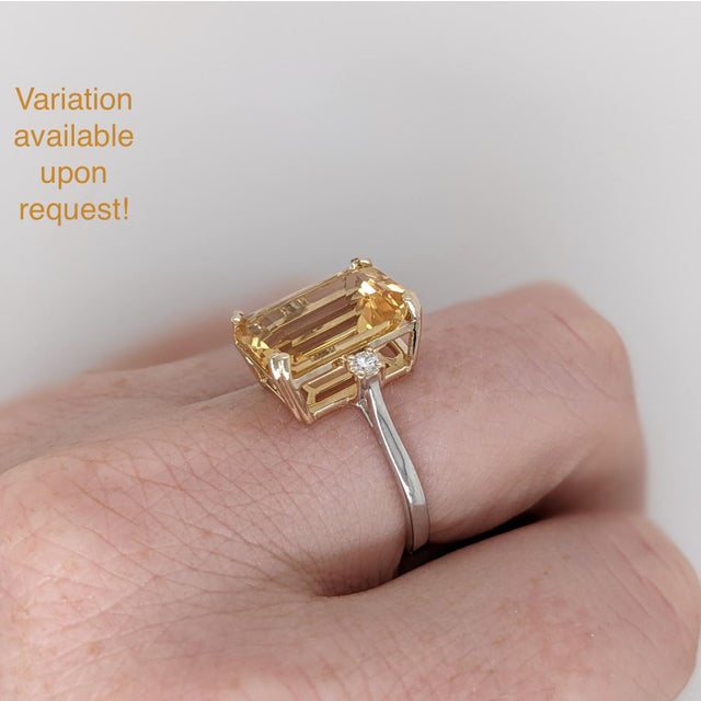 This statement ring features a 7 carat emerald cut citrine with two round natural earth-mined diamond accents in solid 14k...